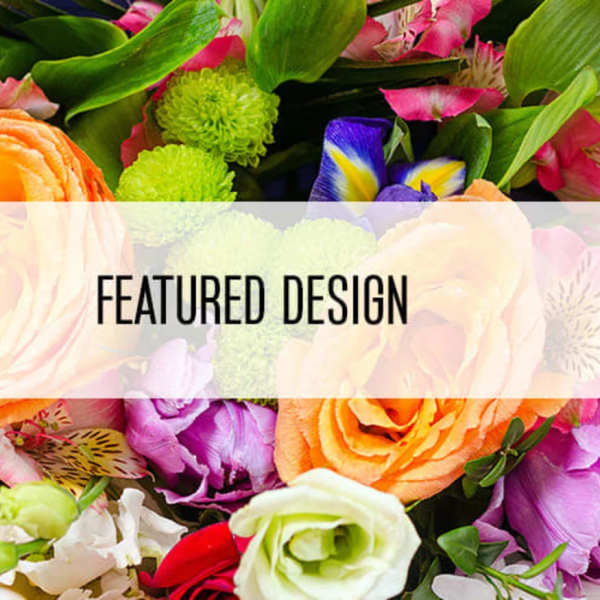 Mixed bouquet with orange roses and pink lilies behind a featured design banner.