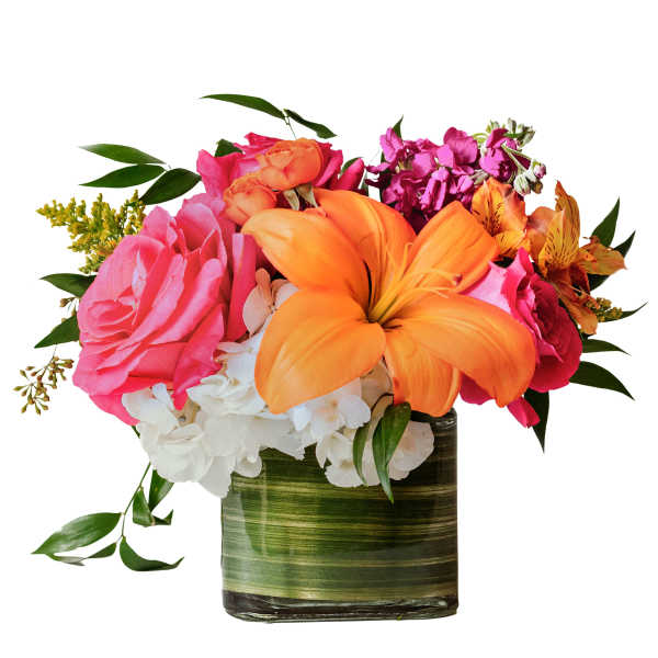 Bright mixed bouquet with orange lilies, pink roses, and white hydrangeas in a glass vase