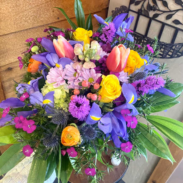Colorful bouquet with tulips, roses, and purple blooms