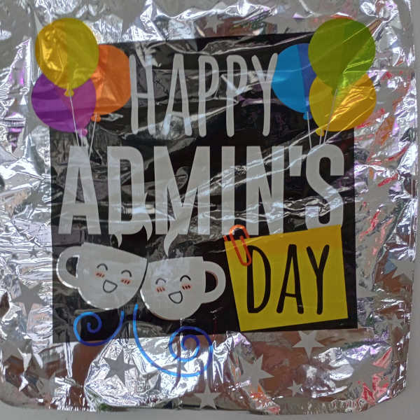 Foil balloon sign reading "Happy Admin's Day" with colorful balloons and coffee cup graphics