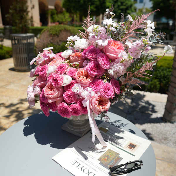 Pink and white rose bouquet in a pedestal vase