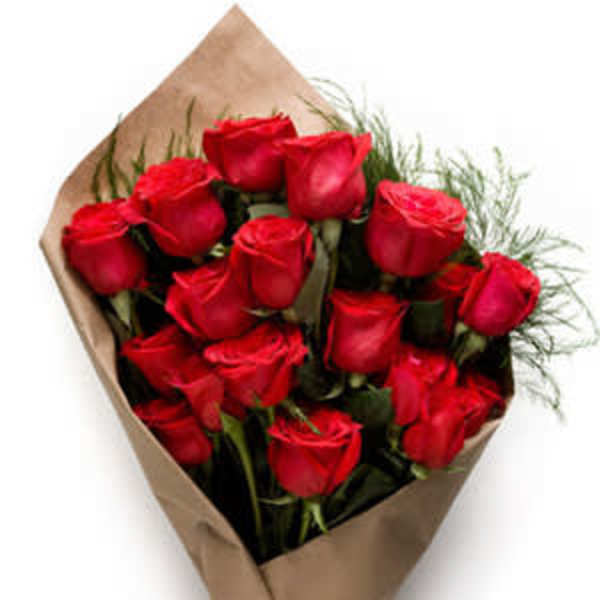 Bouquet of red roses wrapped in brown paper