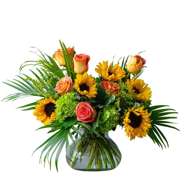 Sunflowers and peach roses arranged in a glass vase