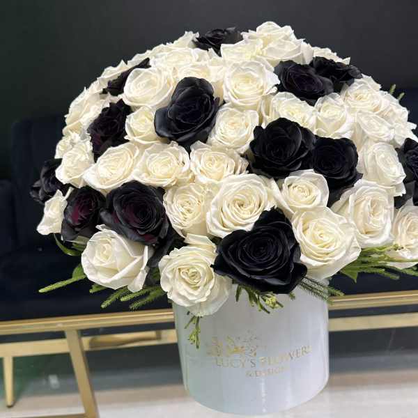 Black and white rose arrangement in a white hat box