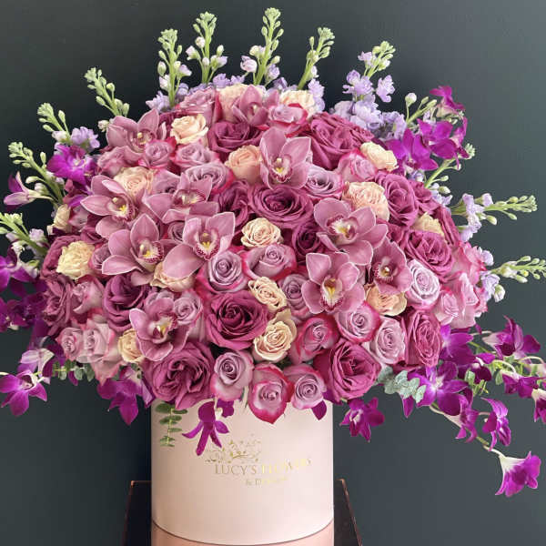Pink and purple rose bouquet in a white hat box