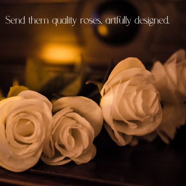 White roses arranged in a warm, dimly lit setting