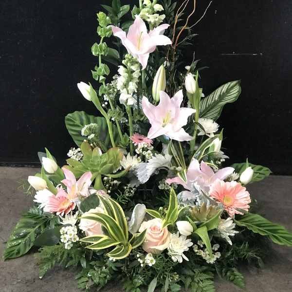 Tall floral spray with pink lilies, white blooms, and greenery