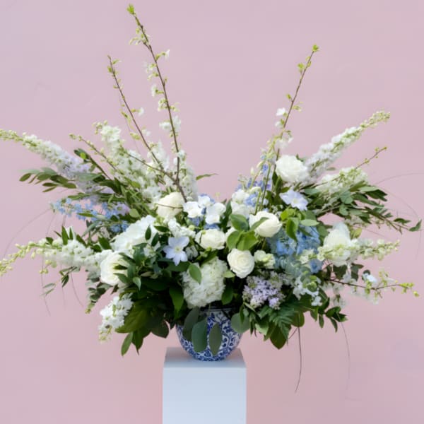 Large white and blue floral arrangement in a blue-and-white vase