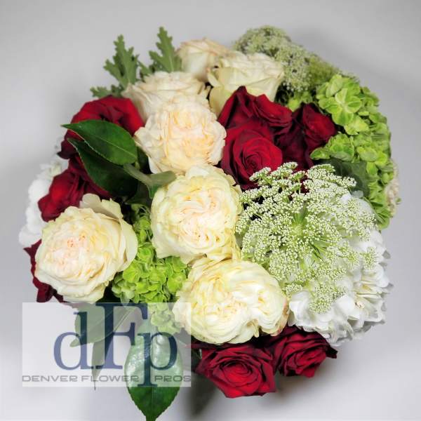 Bouquet of red and cream roses with green hydrangea and white filler flowers