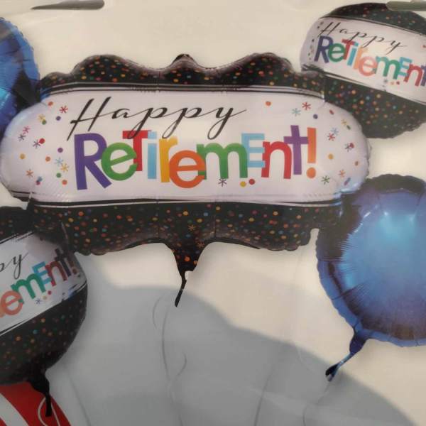 Cluster of retirement-themed foil balloons in black and blue