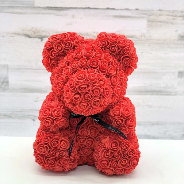 Red rose teddy bear with a black ribbon bow