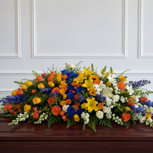 Large multicolored floral casket spray with roses and lilies