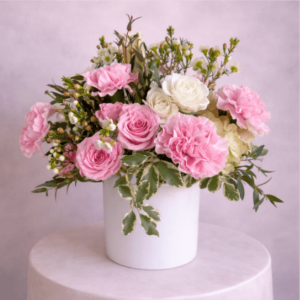 Pink and white rose bouquet in a white vase