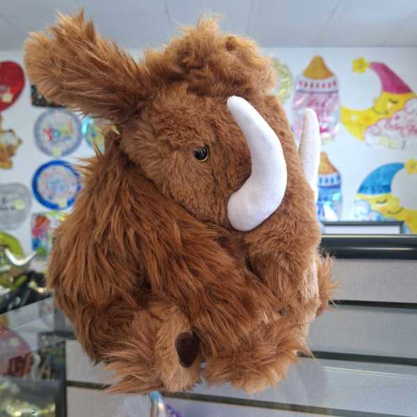 Brown plush mammoth toy with white tusks