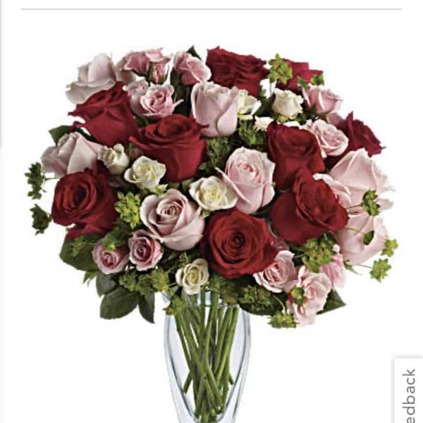 Bouquet of red and pink roses in a clear glass vase