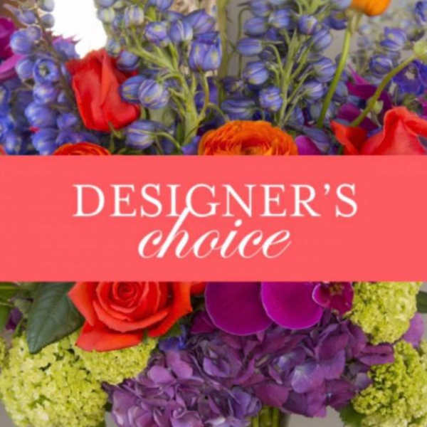 Colorful mixed flower arrangement with a "Designer’s choice" sign