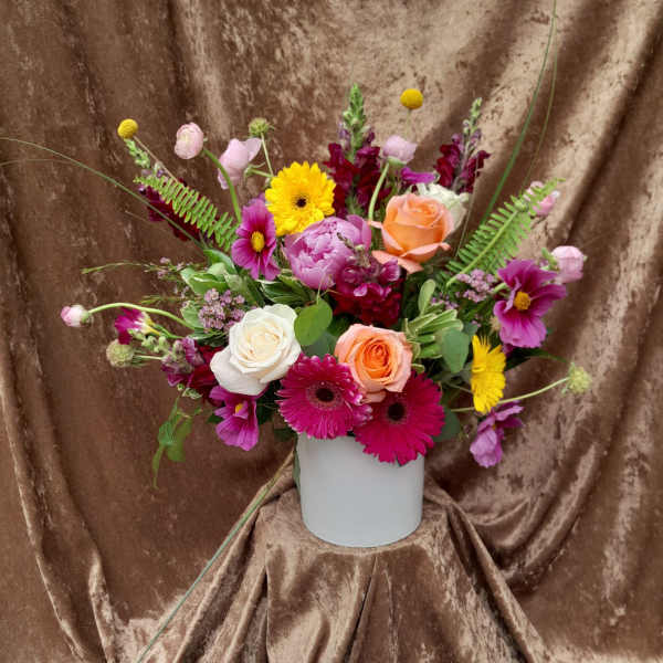 Mixed bouquet in a white vase with roses, gerbera daisies, and snapdragons