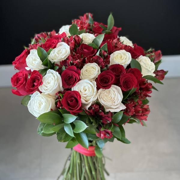 Bouquet of red and white roses with greenery