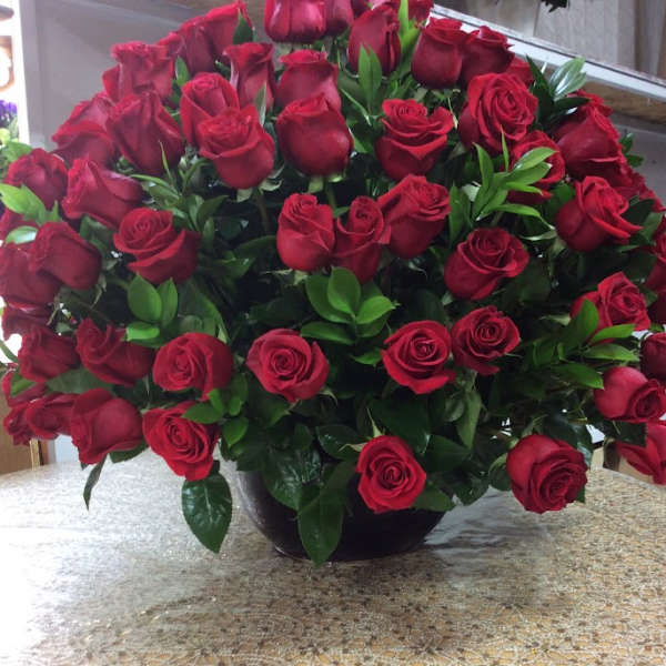 Large bouquet of red roses in a black vase