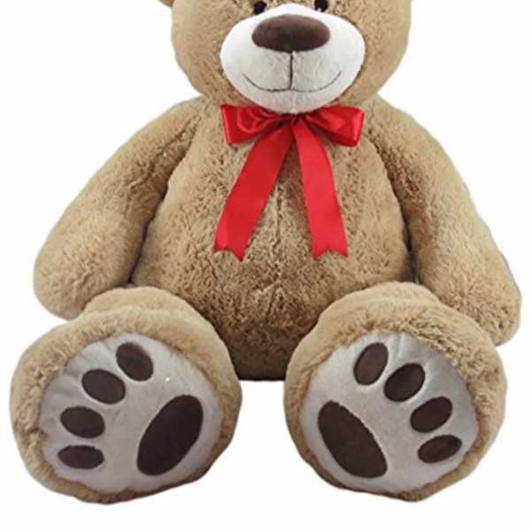Plush teddy bear with a red ribbon bow