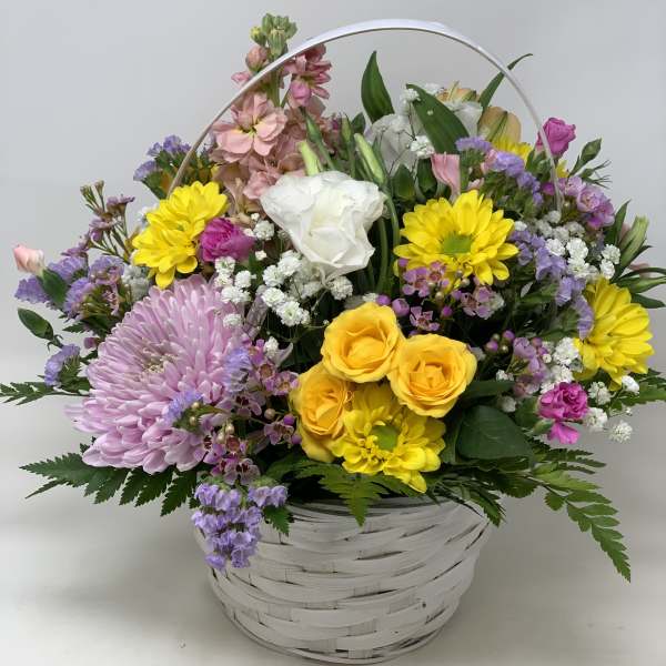 Mixed flower basket with yellow, pink, purple, and white blooms