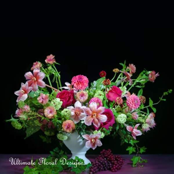 Mixed pink floral arrangement in a white vase