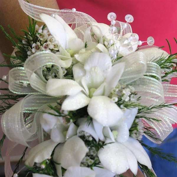 White floral bouquet with ribbon and pearl accents