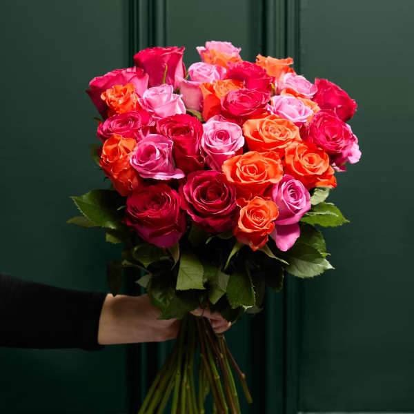 Handheld bouquet of pink, red, and orange roses