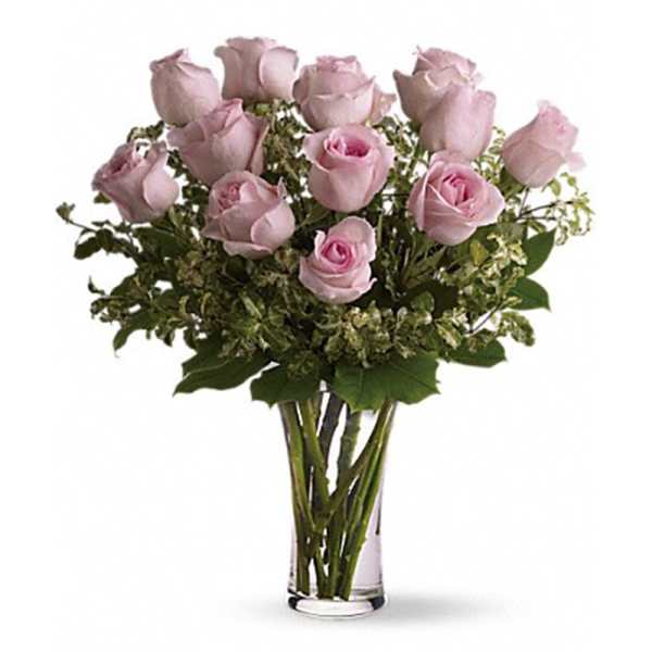 Pink roses arranged in a clear glass vase