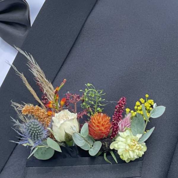 Colorful boutonniere on a dark suit jacket