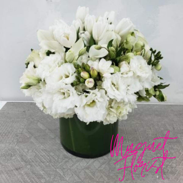 White floral arrangement in a dark green vase