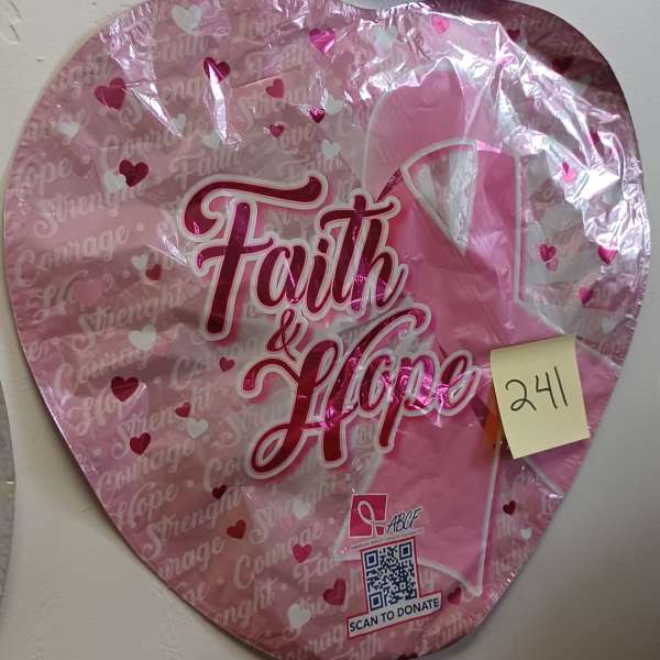 Pink heart-shaped balloon with "Faith & Hope" text and a breast cancer ribbon