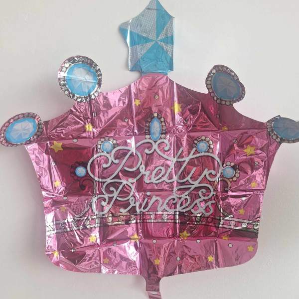Pink crown-shaped foil balloon with "Pretty Princess" text