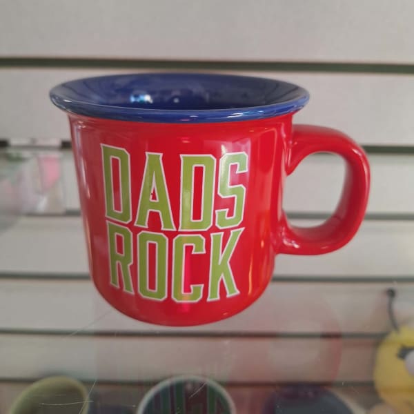 Red mug with blue rim and "DADS ROCK" text