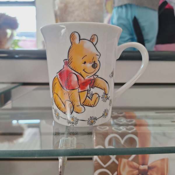 White mug with a Winnie the Pooh illustration