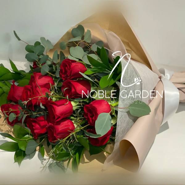 Bouquet of red roses wrapped in beige paper