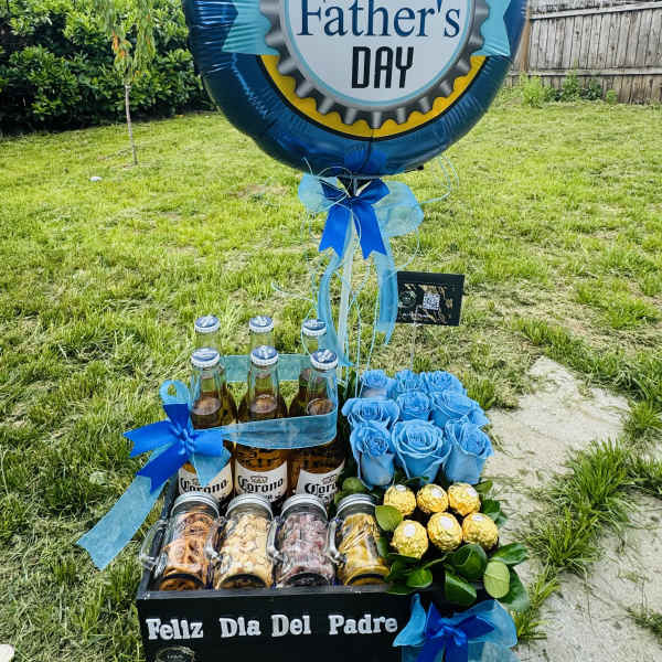 Father's Day gift display with balloons, beer bottles, snacks, and blue roses