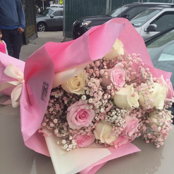 Pink and cream rose bouquet wrapped in pink paper