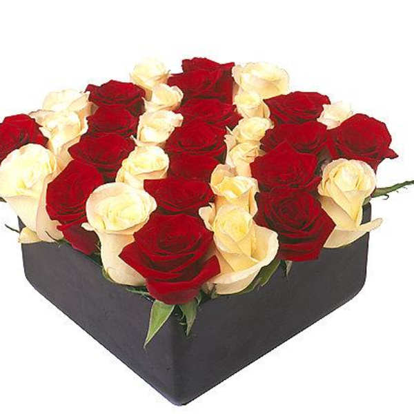 Heart-shaped box filled with red and white roses