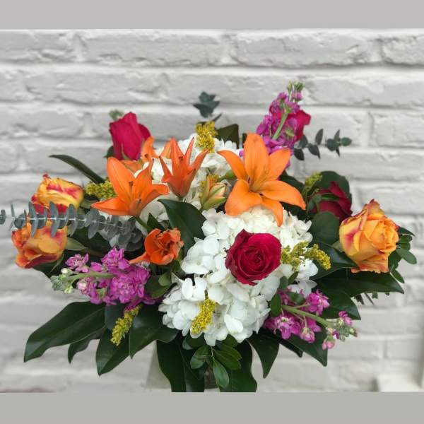 Mixed bouquet with orange lilies, roses, and white hydrangeas