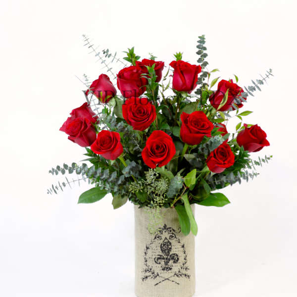 Red roses arranged in a burlap-wrapped vase