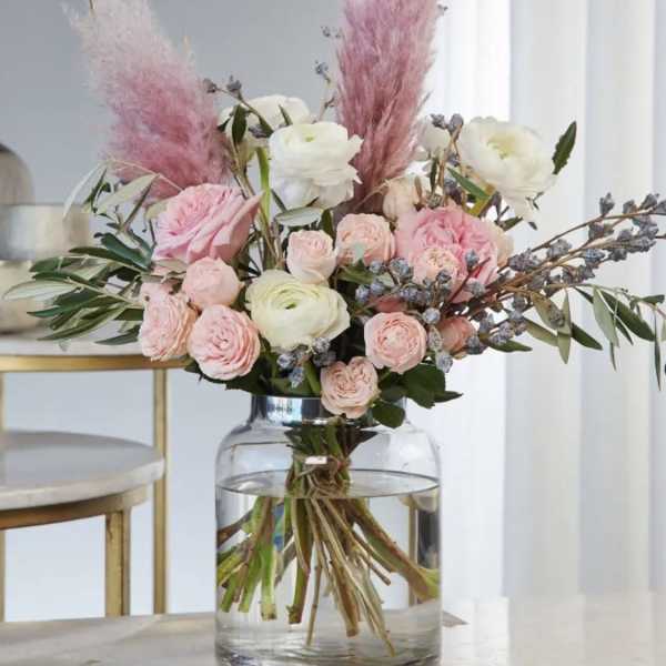 Pink and white floral arrangement in a clear glass vase