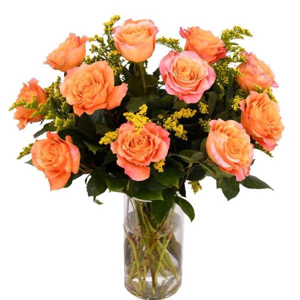 Orange roses arranged in a clear glass vase