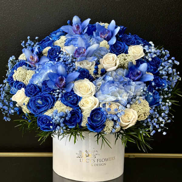 Blue and white floral arrangement in a white box