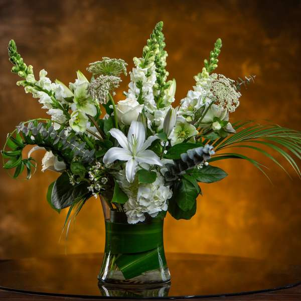 White floral arrangement in a clear glass vase