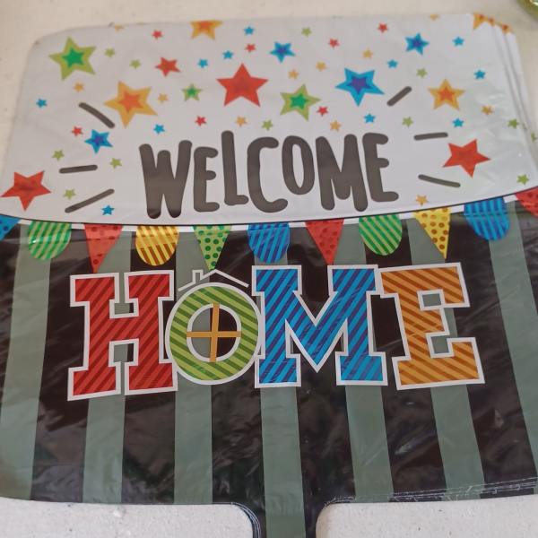 Colorful welcome home party banner with stars and pennants