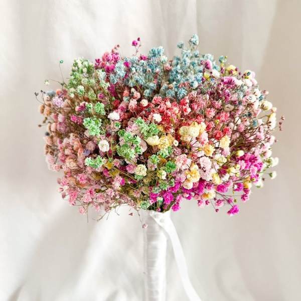 Colorful bouquet of tiny clustered flowers tied with a white ribbon