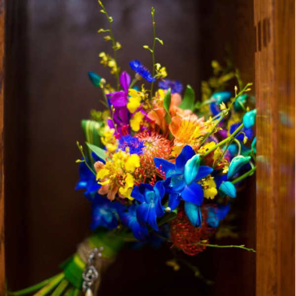 Bright multicolored bouquet with blue, purple, yellow, and peach flowers