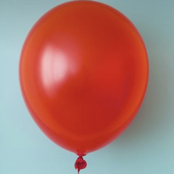 Red balloon with a curled ribbon against a light blue background