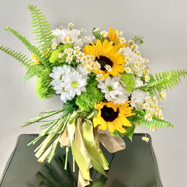 Bouquet of sunflowers and white daisies with green fern accents
